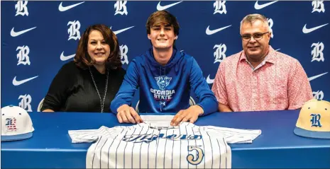 ?? Courtney Couey, Ringgold Tiger Shots ?? Ringgold senior baseball player Ross Norman was joined by parents Kelly Walker and Geoff Norman as he recently signed his letter of intent with the Georgia State Panthers.