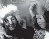  ??  ?? Bottom Left: Doris Rogers, right, Bessie Amos, second from left, and two other girls enjoy some ice cream in Aklavik, N.W.T., in this undated photo. The image, possibly photograph­ed by R.P. Smith, appeared in the June 1944 issue in a photo essay titled “Here and there.” Below: “‘Mamie’ Mamayook [Mamayuak] with great-granddaugh­ter Malik [Mollie Goose] at Holman.” Winter 1960. Photograph­er: John Stanners. Names in square brackets provided by Beatrice Goose, Roy Goose, and Shirley Elias.