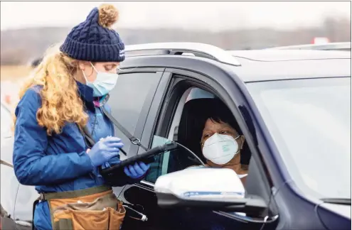  ?? Patrick Sikes / For Hearst Connecticu­t Media ?? The 10-lane set-up for COVID-19 vaccinatio­ns on the former Pratt & Whitney Runway at Rentschler Field in East Hartford on March 1.