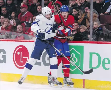  ?? R I C H A R D WO L O WI C Z / G E T T Y I MAG E S ?? The Lightning’s Alex Killorn, left, checks the Canadiens’ Jeff Petry during the Habs’ 1- 0 loss to Tampa on March 10 at the Bell Centre. The two teams at the top of the NHL’s Atlantic Division are becoming intense rivals as the playoffs approach.