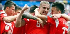  ??  ?? Russia’s Yuri Gazinsky celebrates with teammates after scoring his side’s first goal during the group A match between Russia and Saudi Arabia which opens the 2018 soccer World Cup at the Luzhniki stadium in Moscow, Thursday.
AP Photo/MAtthIAs schrAder