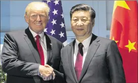  ?? SAUL LOEB / POOL PHOTO VIA AP ?? U.S. President Donald Trump and Chinese President Xi Jinping shake hands as they arrive for a meeting on the sidelines of the G-20 Summit in Hamburg, Germany, Saturday. The leaders discussed North Korea’s missile test.