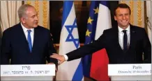  ?? The Associated Press ?? French President Emmanuel Macron, right, and Israeli Prime Minister Benjamin Netanyahu attend a press conference Sunday in Paris. Macron reaffirmed his “disapprova­l” of U.S. President Donald Trump’s move to recognize Jerusalem as the capital of Israel.