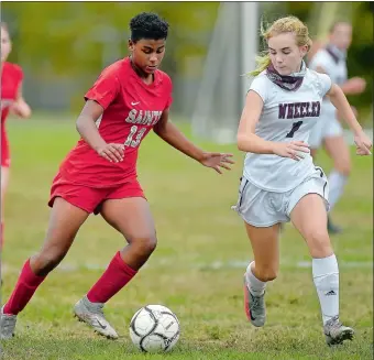  ?? SARAH GORDON/THE DAY ?? St. Bernard’s Angelica Tompkins, left, tries to move past Wheeler’s Leah Cleary during Wednesday’s ECC girls’ soccer match at Montville. Tompkins scored a goal as the Saints defeated the Lions 2-0. To view a photo gallery visit www.theday.com