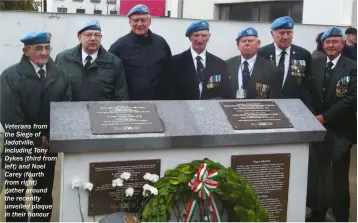  ??  ?? Veterans from the Siege of Jadotville, including Tony Dykes (third from left) and Noel Carey (fourth from right) gather around the recently unveiled plaque in their honour
