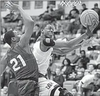  ?? NWA Democrat- Gazette/ ANDY SHUPE ?? North Little Rock guard Deion Dobbins ( right) fl ips up a shot around Conway defender Kendarious Smith during the Class 7A boys state basketball tournament Thursday at Van Buren. Dobbins fi nished with 15 points as the Charging Wildcats beat the Wampus Cats 67- 58.