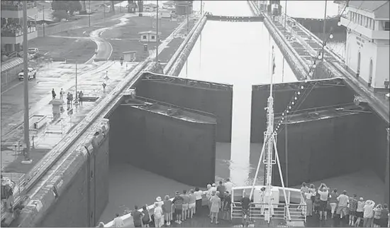  ?? Photos: Mansoor Ladha ?? Passengers gather on the front deck to witness the opening of locks of the Canal, a passage that costs $35,000 per ship.