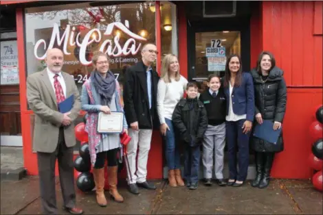  ?? LAUREN HALLIGAN — TROY RECORD ?? Mi Casa owner Brunilda “Kury” Ketcham is joined by family and local officials at the eatery’s ribbon cutting ceremony on Tuesday.