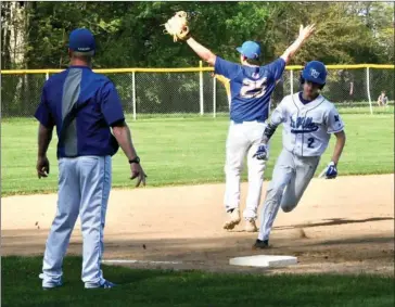  ?? PILOT PHOTO/RON HARAMIA ?? Laville was busy on the base paths in its win Thursday night over Triton. Here Andrew Wolford (2) rounds third base on his way to scoring for the Lancers. Awaiting the throw back into the infield is Triton’s Lucas Kaufman (25).