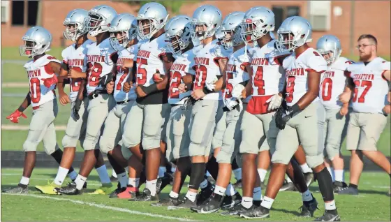  ?? Jeremy stewart, file ?? Cedartown football players walk across the field after warming up prior to their game against Rockmart last season.