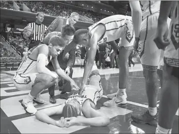  ?? Michael Owen Baker Associated Press ?? BENNIE BOATWRIGHT lies on the floor after injuring his knee in USC’s game against Oregon on Thursday.