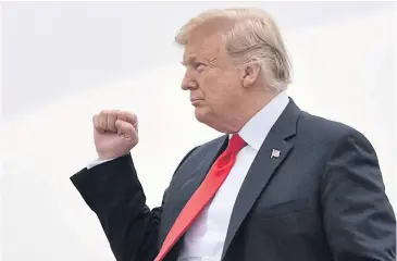  ?? AFP ?? US President Donald Trump gestures as he steps off Air Force One upon arrival for a ‘Make America Great Again’ rally in Topeka, Kansas yesterday.
