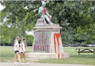  ?? AP PHOTO/MARK HUMPHREY ?? In 2019, people walk past a monument to Confederat­e soldiers in Centennial Park in Nashville.