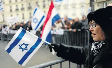  ?? /AFP Photo ?? Make a stand: Demonstrat­ors wave flags and shout slogans during a rally in Paris on Sunday against the Paris Middle East peace conference. Three French Jewish groups called for a protest to denounce the conference.