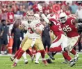  ??  ?? San Francisco 49ers quarterbac­k C.J. Beathard braces for a hit by Cardinals strong safety Budda Baker in the fourth quarter Sunday.