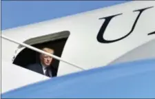  ?? SUSAN WALSH - THE ASSOCIATED PRESS ?? President Donald Trump steps through the door of Air Force One at Morristown Municipal Airport in Morristown, N.J., Friday. Trump is spending the weekend in Bedminster, N.J., at his golf club.