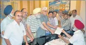  ?? HT PHOTO ?? AAP district chief Suresh Sharma (wearing the party cap) and others handing over a memorandum to the DC in Amritsar.