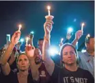  ?? DOROTHY EDWARDS/USA TODAY NETWORK ?? People attend a candleligh­t vigil Feb. 15 at Pine Trails Park after the shooting took 17 lives at Marjory Stoneman Douglas High School.