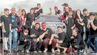  ?? BEVAN READ / FAIRFAX NZ ?? Ricky Barker’s brother Jonathan and father Pete, far left, and mother Kaye, leaning against the car, with friends and family beside Ricky Barker’s cherished Nissan Skyline.