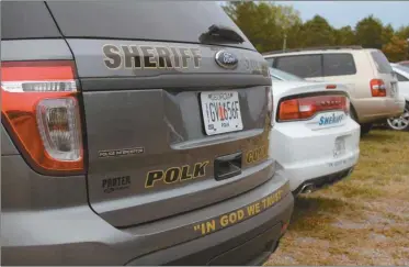  ??  ?? Polk County Sheriff’s officials have been adding “In God We Trust” their rear bumpers.