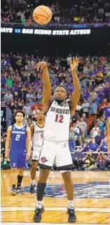  ?? ?? After missing first, Darrion Trammell makes the second free throw with 1.2 seconds left.