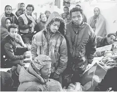  ??  ?? Illegal migrants sit in an immigratio­n holding centre located on the outskirts of Misrata. — AFP photo