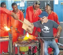  ??  ?? FRAGILE BEAUTY: Madoda Hlongwane, above, blows a glass by designer Laurie Wiid van Heerden; Davide Salvadore, left, at work, and his kudu creation