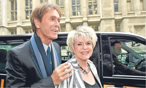  ??  ?? CHOKED: Sir Cliff Richard arrives at court with Gloria Hunniford yesterday, he broke down giving evidence about damage to his reputation