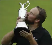  ?? MATT DUNHAM — THE ASSOCIATED PRESS ?? Ireland’s Shane Lowry kisses the Claret Jug after his first major win in the British Open, the first Open held in Northern Ireland in 68years.