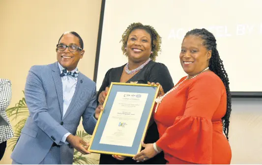  ?? KENYON HEMANS/PHOTOGRAPH­ER ?? Minister of State in the Ministry of Industry, Investment and Commerce, Norman Dunn, and Manager of the National Certificat­ion Body of Jamaica, Navenia Wellington Ford (centre), pose with Managing Director of EXIM Bank Jamaica, Lisa Bell, following the presentati­on of a Quality Management System ISO 9001: 2015 certificat­e to EXIM Bank, at a certificat­ion ceremony held at AC Hotel by Marriott in New Kingston on January 18, 2023.