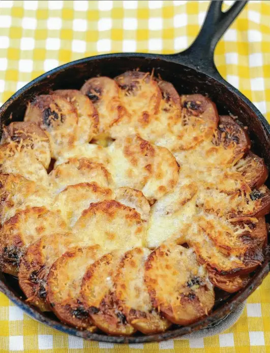  ??  ?? Sweet Onion, Sausage and Potato Gratin can be a hearty main dish or a cheesy side. Recipe, Page E8.
Paul Stephen / Staff