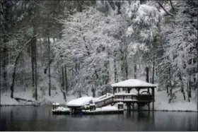  ?? KATHY KMONICEK — THE ASSOCIATED PRESS ?? A dock and gazebo is covered with a thick layer of snow on Lake James, Sunday in Morganton, N.C. Over a foot of snow fell in the area creating a winter wonderland.