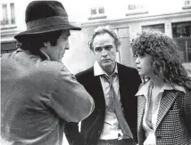  ?? AP ?? Bertolucci with Marlon Brando and Maria Schneider during the shooting of Last Tango in Paris, the scandalous film that made his name.