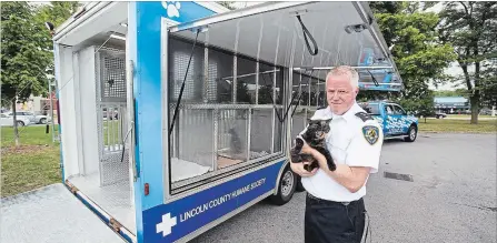  ?? JULIE JOCSAK THE ST. CATHARINES STANDARD ?? Kevin Strooband, executive director of Lincoln County Humane Society, is photograph­ed by the new truck and trailer that was purchased from Pennsylvan­ia to help bring animals to events for adoption.