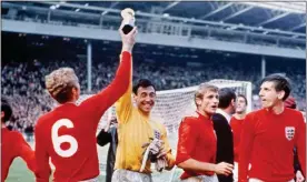  ??  ?? Pure gold: Gordon Banks holds the World Cup aloft along with captain Bobby Moore