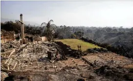  ?? JAE C. HONG / AP ?? A home in Malibu, Calif., that overlooked the Pacific Ocean lies in ruins Sunday after being consumed by one of several wildfires ravaging the state.