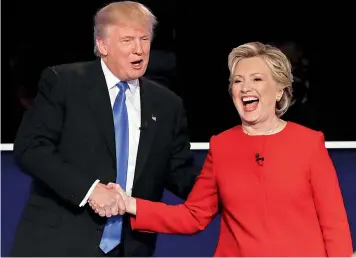  ?? — AP ?? Democratic presidenti­al nominee Hillary Clinton and Republican presidenti­al nominee Donald Trump shake hands during the presidenti­al debate at Hofstra University in Hempstead, N.Y.