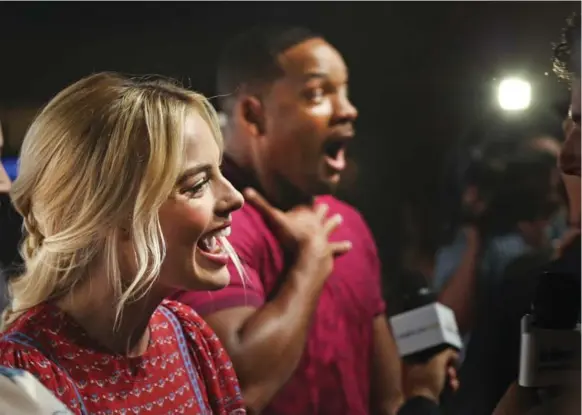  ?? RICHARD LAUTENS/TORONTO STAR ?? Actors Margot Robbie and Will Smith talk to the media at the launch of the Toronto Belle Reve Penitentia­ry Fan Experience for Suicide Squad in the Distillery District.