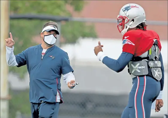  ?? MATT STONE / BOSTON HERALD ?? Patriots offensive coordinato­r Josh McDaniels speaks with quarterbac­k Cam Newton during practice on Wednesday.