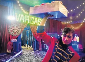  ??  ?? FACUNDO KRAMER, a performer for Circus Vargas, sells popcorn between shows. “Every single person in our show wears many hats,” said Nelson Quiroga, who co-owns the circus with his wife, Katya.