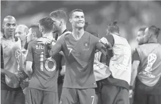  ?? DEAN MOUHTAROPO­ULOS/GETTY IMAGES ?? Cristiano Ronaldo celebrates after scoring one of Portugal’s three goals during its Group B match draw against Spain on Friday.