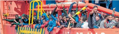  ?? Pictures: MARCOS MORENO / AFP ?? Migrants show their delight as they are safely on board the Spanish rescue boat and heading to mainland