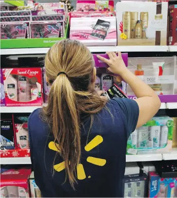  ?? PATRICK T. FALLON/BLOOMBERG FILES ?? Walmart says its move to expand self-serving technology in Canadian stores is not meant to eliminate jobs. However, Sunil Johal, policy director at The Mowat Centre at the University of Toronto, predicts such moves will eventually lead to cuts in...