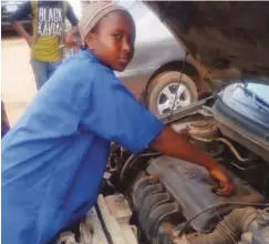  ??  ?? Chilaka works on a vehicle at a workshop in Bwari, Abuja