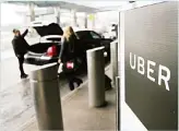  ??  ?? In this file photo, a sign marks a pick up point for the Uber car service at LaGuardia Airport in New York. Ride-hailing giant Uber has filed confidenti­al preliminar­y paperwork for selling stock to the public. (AP)