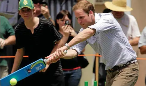  ?? PHOTO: LUIS ENRIQUE ASCUI/AAP ?? Prince William plays a game of cricket with children of Flowerdale Village, a bushfire effected zone, during his Melbourne visit in 2010.