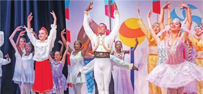  ??  ?? Kenyan ballet dancer Joel Kioko, 16, center, dances in a performanc­e of The Nutcracker in Nairobi, Kenya. — AP photos