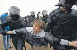  ?? AP PHOTO ?? Police detain a protester during anti corruption rally in St. Petersburg, Russia.