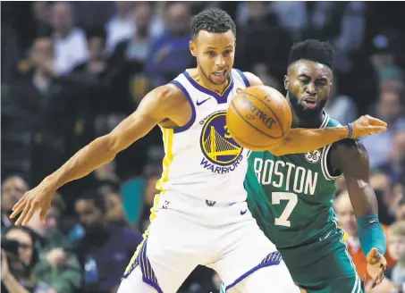  ?? Michael Dwyer / Associated Press ?? The Warriors’ Stephen Curry and Boston’s Jaylen Brown go after a loose ball. Brown scored 22 points, 13 more than Curry did.