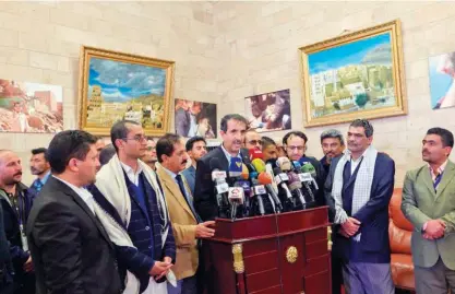  ?? Agence France-presse ?? Houthi rebel delegation member Jalal Al Ruwaishan (centre) speaks at a press conference upon his arrival from peace talks in Sweden at Sanaa Internatio­nal Airport in the Yemeni capital on Friday.